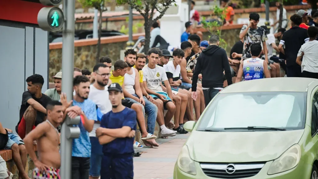 Migrants crossing border into Ceuta during the Ceuta Crisis, highlighting Spain's legal obligations.