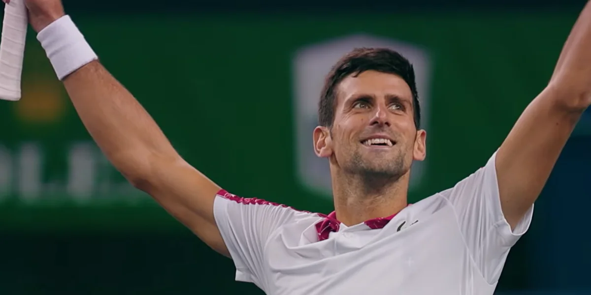 Novak Djokovic in action on a tennis court, looking intense.