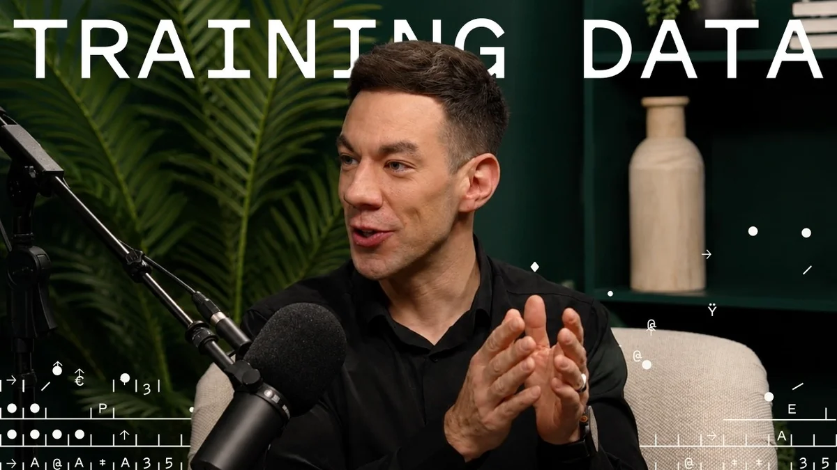 Jake Stauch and interviewer in a modern office setting discussing AI and IT.