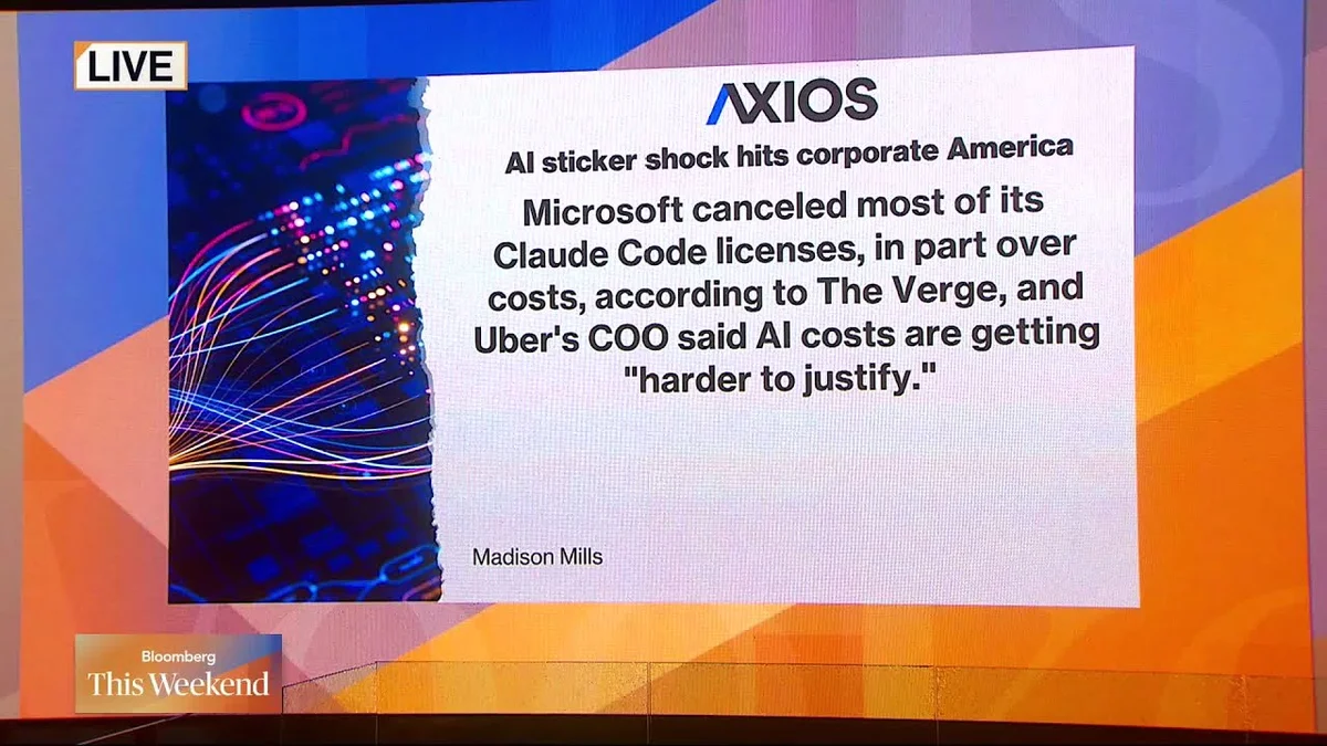 Three people in a studio discussing AI costs, with a large screen showing server racks in the background.