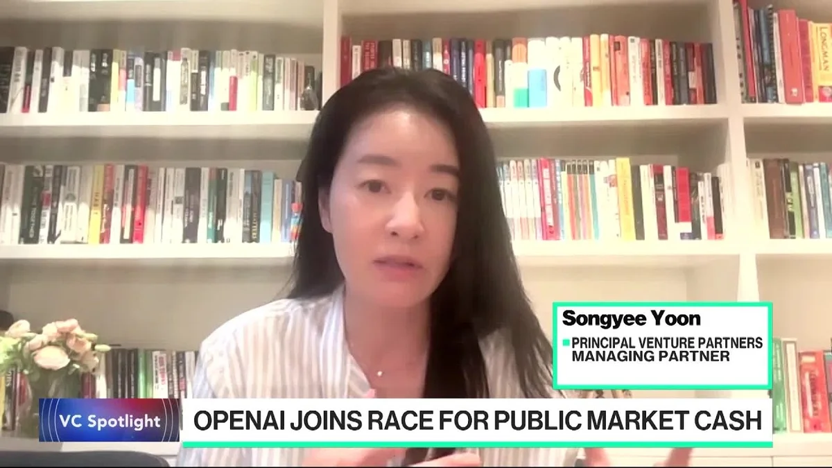 Woman speaking on Bloomberg Tech, with graphics showing market data and company logos.