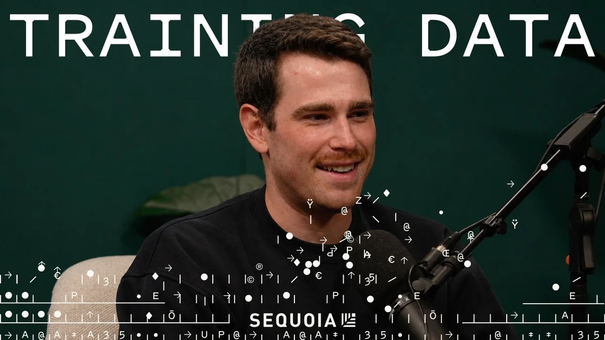 Logan Kilpatrick and an interviewer sitting in chairs, discussing AI