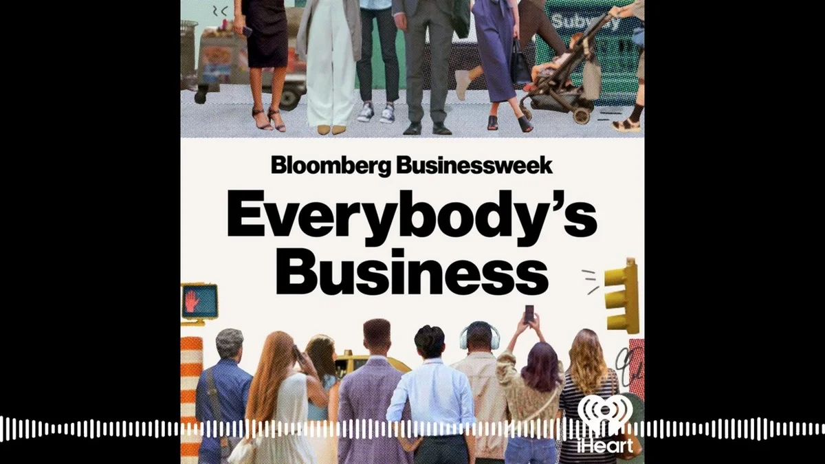 Group of people viewed from behind, looking towards a city skyline with a Bloomberg Businessweek logo.