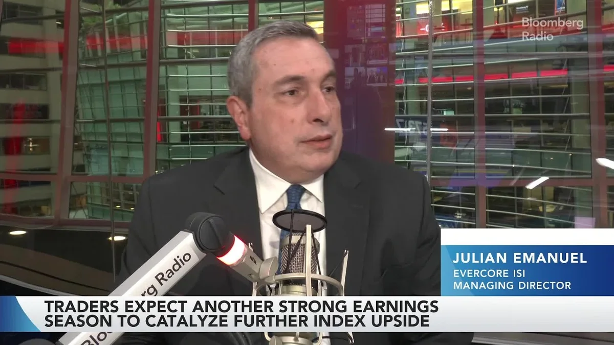 Man in a suit speaking into a microphone with Bloomberg Radio branding.