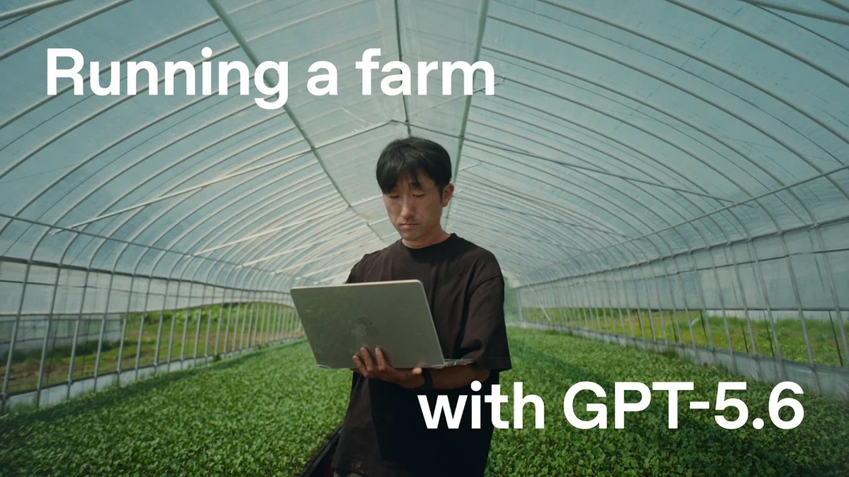 Broccoli farmer Hiroki Tomiyasu in a greenhouse holding a laptop.