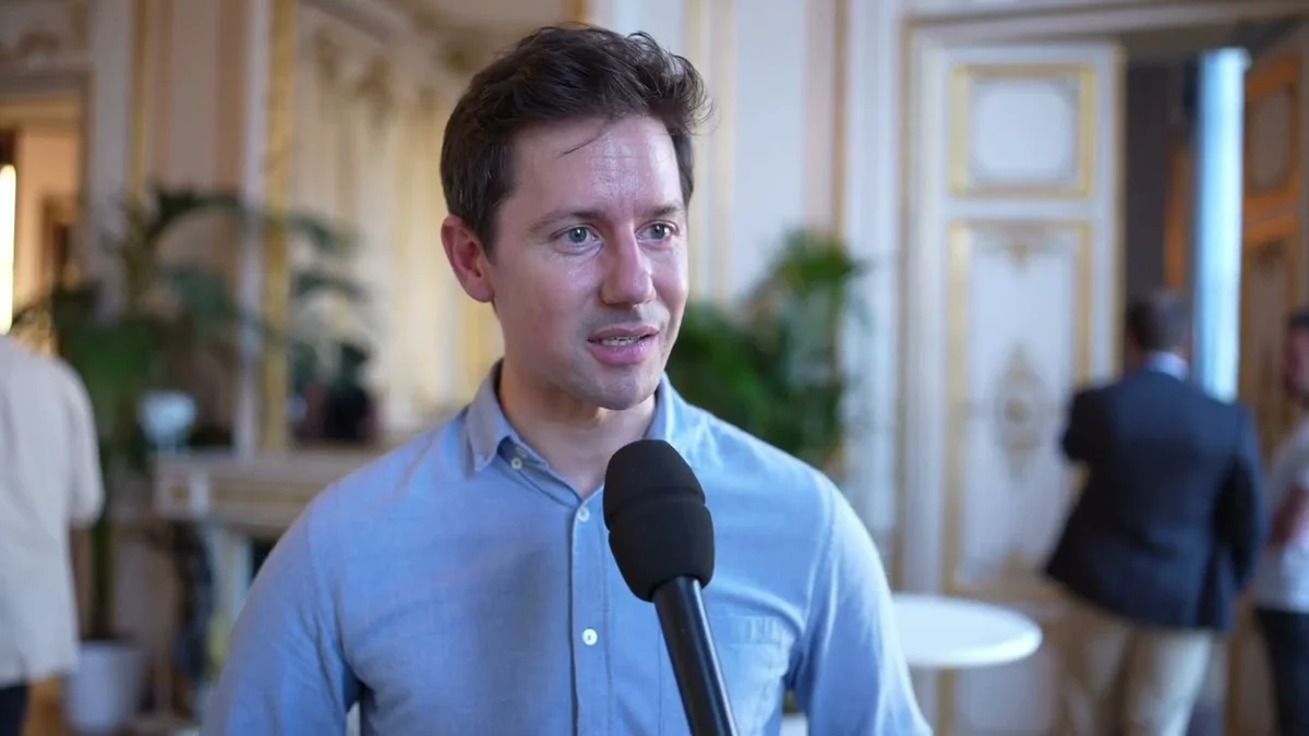 Romain Huet, Head of Developer Experience at OpenAI, speaks into a microphone.
