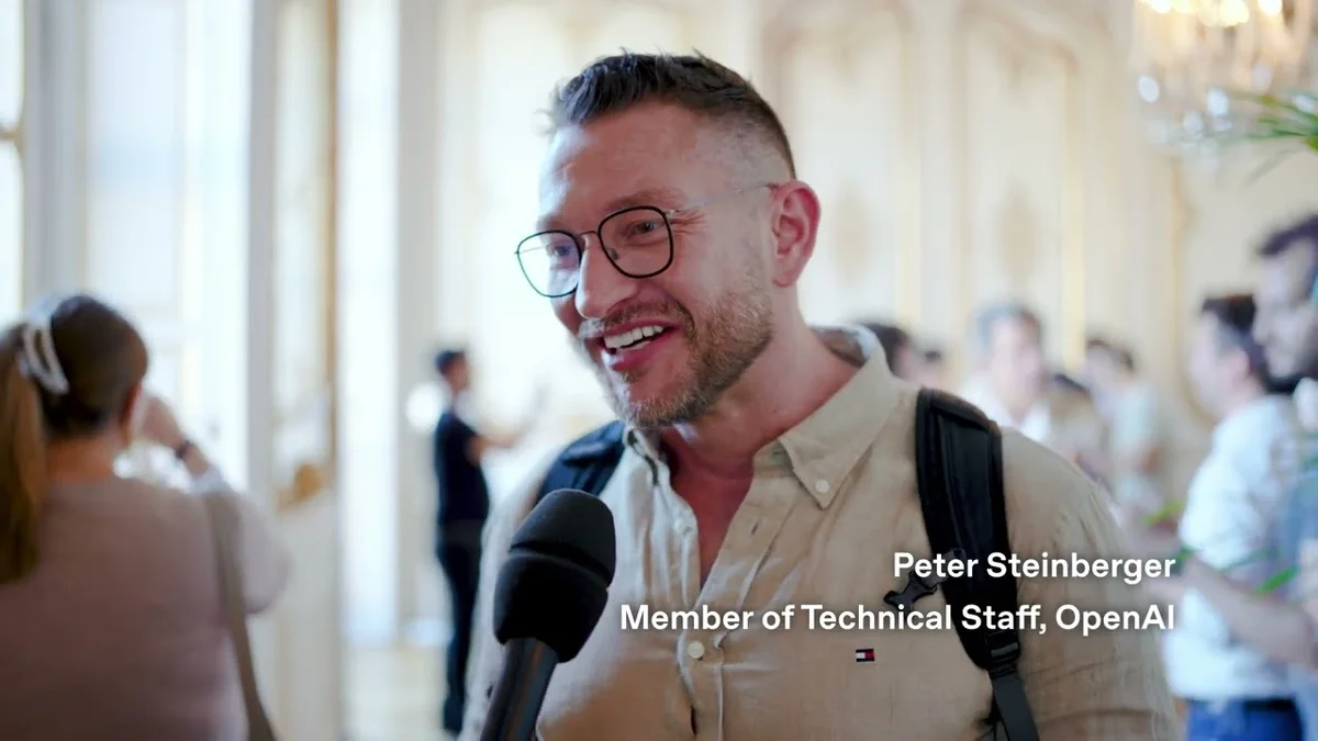 Peter Steinberger of OpenAI speaking at an event, wearing glasses and a light-colored shirt, holding a microphone.