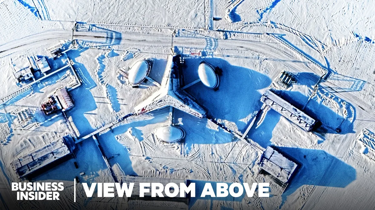 Satellite image showing a vast, icy Arctic landscape with a single icebreaker ship navigating through the frozen sea.