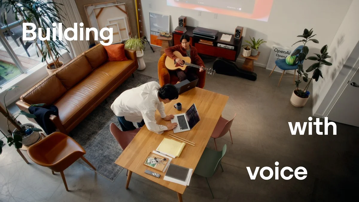 Two individuals collaborating in a modern office space, with a projector screen displaying ChatGPT interface.