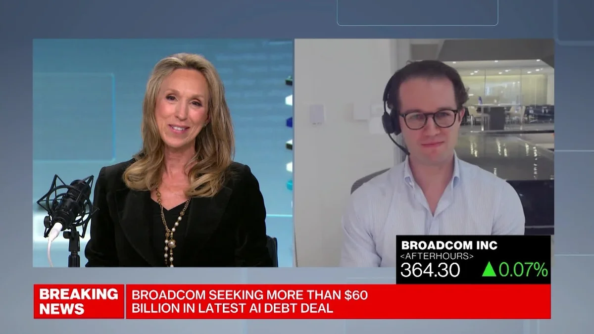 Two people in a split screen, one a female anchor and the other a male reporter discussing business news.